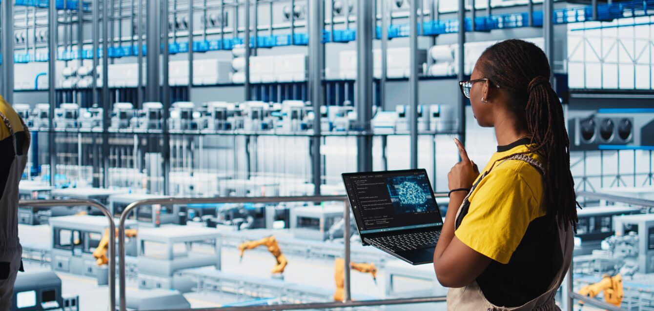 Engineer in smart factory using augmented reality to collect data on laptop. Professional on platform in industry 4.0 industrial plant equipped with sensors using AI technology, camera A Manufacturing Operational Intelligence Beyond MES and SCADA to Context-Aware Workflows